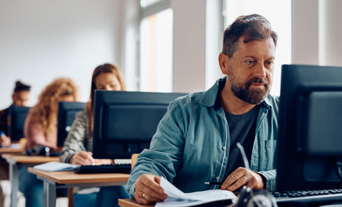 Adults in a classroom setting at desks