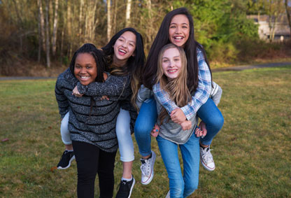 4 Middle school girls smiling for the camera 